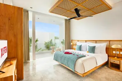 a bedroom with a large bed and a large window at Heleina Elegant 3 BR Royal Private Pool Villa With Jacuzzi in Legian