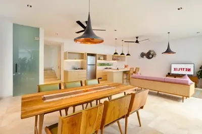 a kitchen and dining room with a wooden table and chairs at Heleina Elegant 3 BR Royal Private Pool Villa With Jacuzzi in Legian