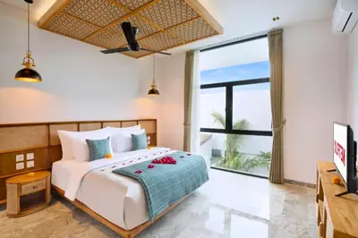 a bedroom with a bed and a large window at Heleina Elegant 3 BR Royal Private Pool Villa With Jacuzzi in Legian