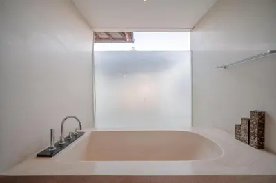 a large bath tub in a bathroom with a window at Stunning villa in Umalas center in Canggu