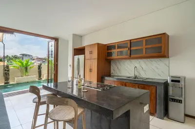 a kitchen with a large island with chairs in it at 2min-walk beach Atlas club,Finns Padi view in Canggu