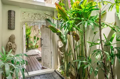 an entrance to a house with plants in theoyer at 2min-walk beach Atlas club,Finns Padi view in Canggu