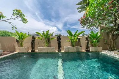 a swimming pool with palm trees and plants at 2min-walk beach Atlas club,Finns Padi view in Canggu
