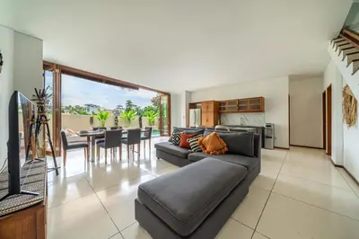 a living room with a couch and a table at 2min-walk beach Atlas club,Finns Padi view in Canggu