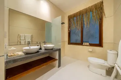 a bathroom with two sinks and a toilet at 2min-walk beach Atlas club,Finns Padi view in Canggu