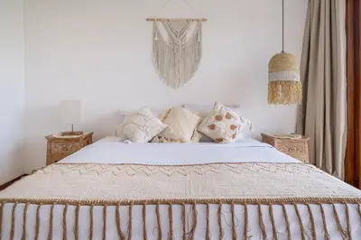 a bedroom with a bed with white sheets and pillows at 2min-walk beach Atlas club,Finns Padi view in Canggu