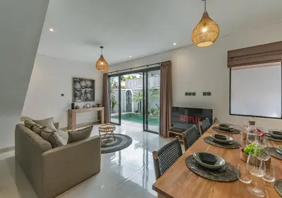 a living room with a table and a couch at Villa Delila in Canguu in Canggu