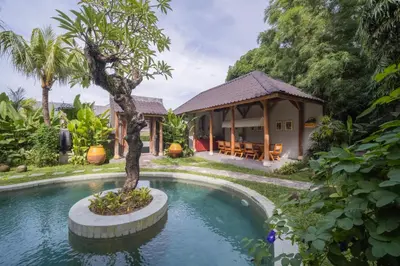 a villa with a pool and a house at Anam Mani New Room Central Seminyak in Seminyak