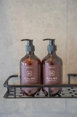 two bottles of soap sitting on a shelf at Anam Mani New Room Central Seminyak in Seminyak