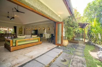 a bedroom with a bed on a patio at Beachside Luxury Private Villa in Sanur in Sanur
