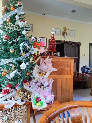 a christmas tree with christmas ornaments on it at Pujihouse One in Legian