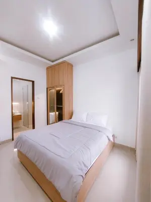 a white bedroom with a large bed in it at Villa Morich in Jimbaran