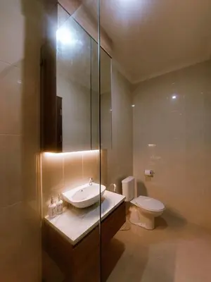 a bathroom with a sink and a toilet at Villa Morich in Jimbaran