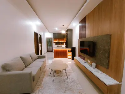 a living room with a couch and a table at Villa Morich in Jimbaran