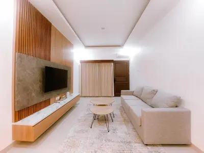 a living room with a couch and a tv at Villa Morich in Jimbaran
