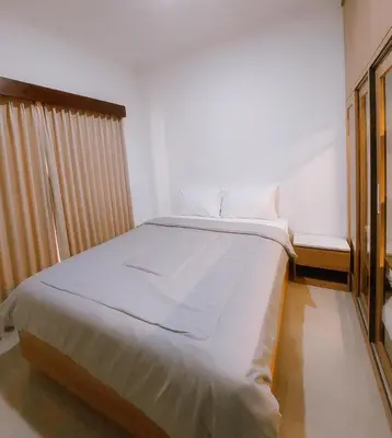 a bedroom with a large white bed in a room at Villa Morich in Jimbaran