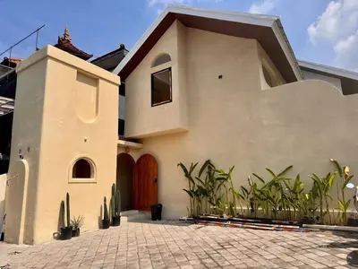 a house with a door and some plants at LoftStyle Villa with nice Private Plunge Pool in Kerobokan