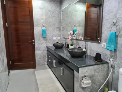 a bathroom with two sinks on a counter at Villa Toya in Legian