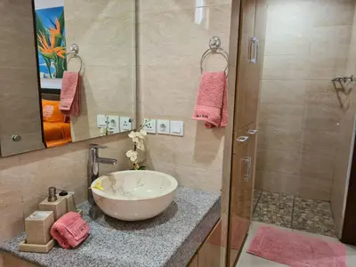 a bathroom with a bowl sink and a shower at Villa Toya in Legian