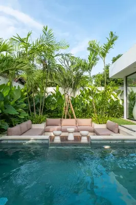 a swimming pool with a couch next to a swimming pool at Villa Aito, Luxury 3 BD Private Villa near Beach - Bali in Seminyak