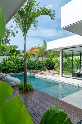 an infinity pool with a palm tree in a villa at Villa Aito, Luxury 3 BD Private Villa near Beach - Bali in Seminyak