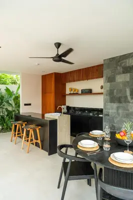 a kitchen with a table and chairs and a counter at Villa Aito, Luxury 3 BD Private Villa near Beach - Bali in Seminyak