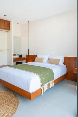 a bedroom with two beds and a table at Villa Aito, Luxury 3 BD Private Villa near Beach - Bali in Seminyak