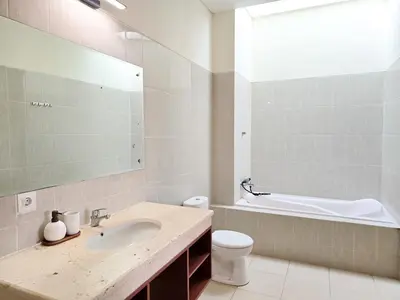 a bathroom with a sink and a toilet and a mirror at 5beds, 10 ppl, 10mins to beach, Private Pool in Sanur