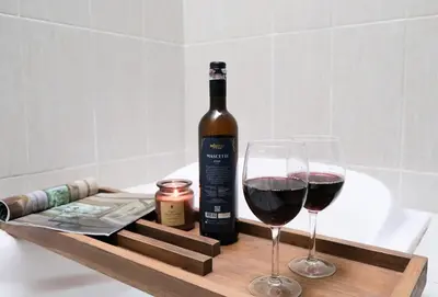a bottle of wine and two glasses on a wooden tray at 5beds, 10 ppl, 10mins to beach, Private Pool in Sanur
