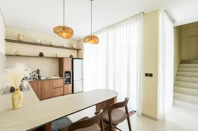 a kitchen with a dining table and chairs at Casa Alden - 3BR Infinity Pool with Ricefield View in Kerobokan
