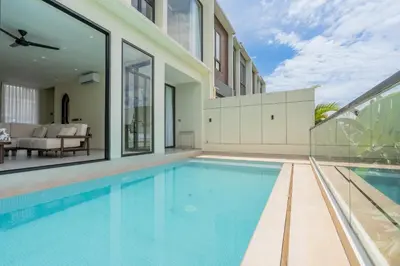 a swimming pool in a house with a patio at Casa Alden - 3BR Infinity Pool with Ricefield View in Kerobokan