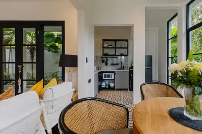 a living room with a table and chairs at Luxury with A Soul - Martini 2 1BR Villa Reimagined in Kerobokan