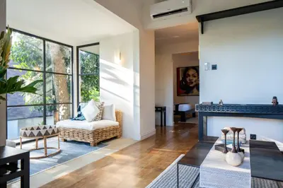 a living room with a fireplace and a couch at Walk into Serenity, Martini 3 - 1BR Treetop Villa in Kerobokan