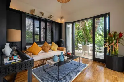 a living room with a couch and a table at Walk into Serenity, Martini 3 - 1BR Treetop Villa in Kerobokan