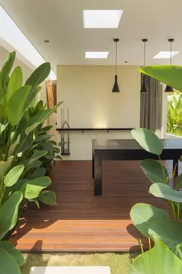 a dining room with a table and some plants at Villa Kina - Tropical 2BR Villa with Pool and Billiard in Seminyak