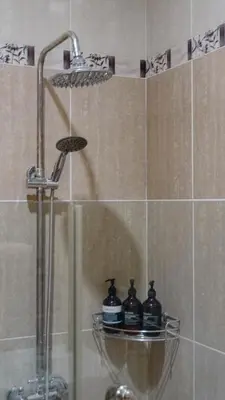 a shower with three bottles on a shelf in a bathroom at 2 Bedroom Villa with Private Pool & Kitchen in Jimbaran