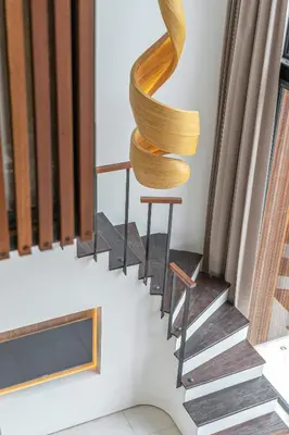 a wooden spiral staircase in a house at Hidden Elements in Canggu