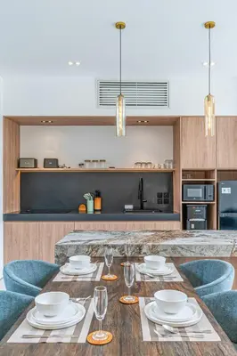 a kitchen with a wooden table with plates and wine glasses at Hidden Elements in Canggu