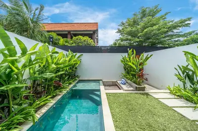 a swimming pool in the backyard of a villa at Hidden Elements in Canggu