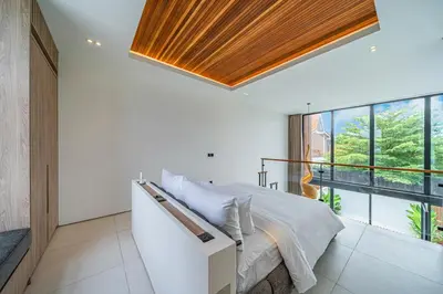 a bedroom with a bed and a large window at Hidden Elements in Canggu