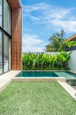 a swimming pool in the backyard of a house at Hidden Elements in Canggu
