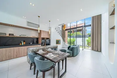 a kitchen and living room with a table and chairs at Hidden Elements in Canggu