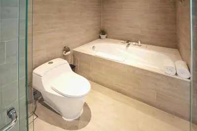 a bathroom with a toilet and a bath tub at Kamaniiya Petitenget Seminyak in Seminyak