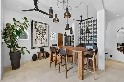 a dining room with a wooden table and chairs at Black Diamond - Luxury 3BR Villa in Umalas in Kerobokan