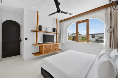 a white bedroom with a bed and a window at Black Diamond - Luxury 3BR Villa in Umalas in Kerobokan