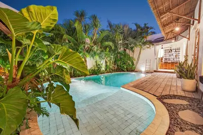 a swimming pool in a yard with plants at Black Diamond - Luxury 3BR Villa in Umalas in Kerobokan