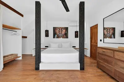 a bedroom with a white bed and a mirror at Black Diamond - Luxury 3BR Villa in Umalas in Kerobokan