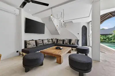 a living room with a couch and a table at Black Diamond - Luxury 3BR Villa in Umalas in Kerobokan