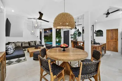 a dining room and living room with a table and chairs at Black Diamond - Luxury 3BR Villa in Umalas in Kerobokan