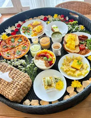 a tray filled with different types of food on a table at Villa Arisanti in Kerobokan
